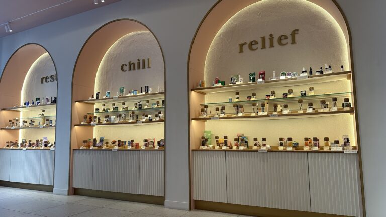 Cannabis products displayed on a shelf in a dispensary.